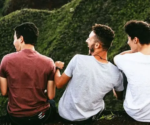 Men sitting on a cliff