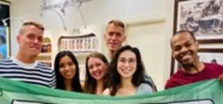 ITA staff holding their banner