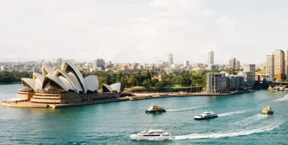 water, opera house, and skyscrapers