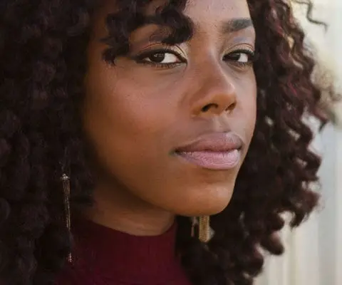 Black woman looking directly at the camera