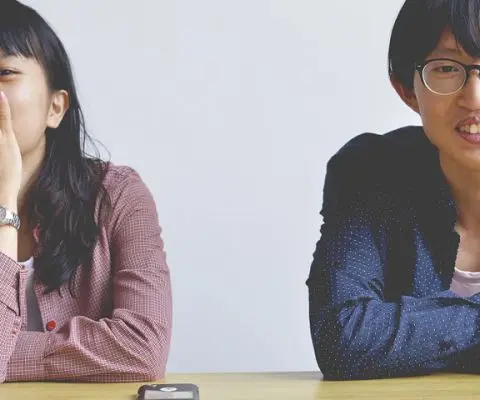 Asian man and woman sitting at a table