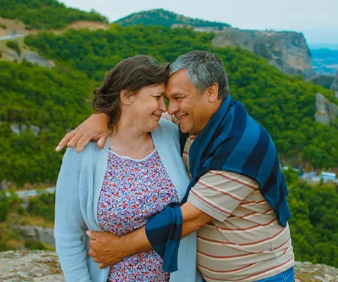 husband and wife posing for cute photo in Greece