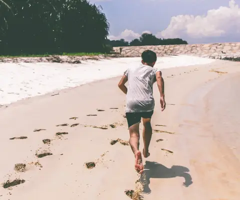 Boy running on beach