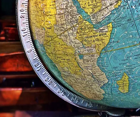 close up of globe in a darkened classroom
